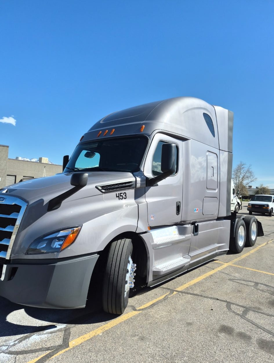A Freightliner Cascadia semi truck in a parking lot